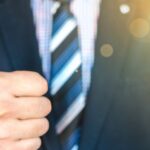 man in suit giving thumbs up sign