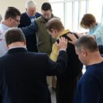 Horst Construction and team prays together before a meeting