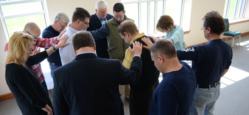 Horst Construction and team prays together before a meeting