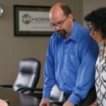 Three Horst office team reviewing the plans for an upcoming construction project in their conference room