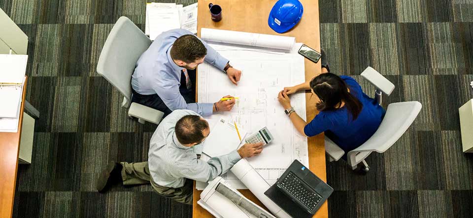 aerial of people looking at plans