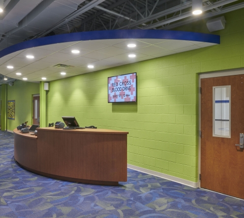 front desk with lime green wall