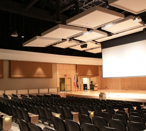 smaller concert room with screen and stage at front of room