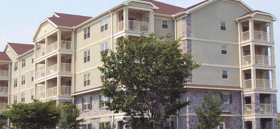 Exterior of 5-story stone and stucco apartment building