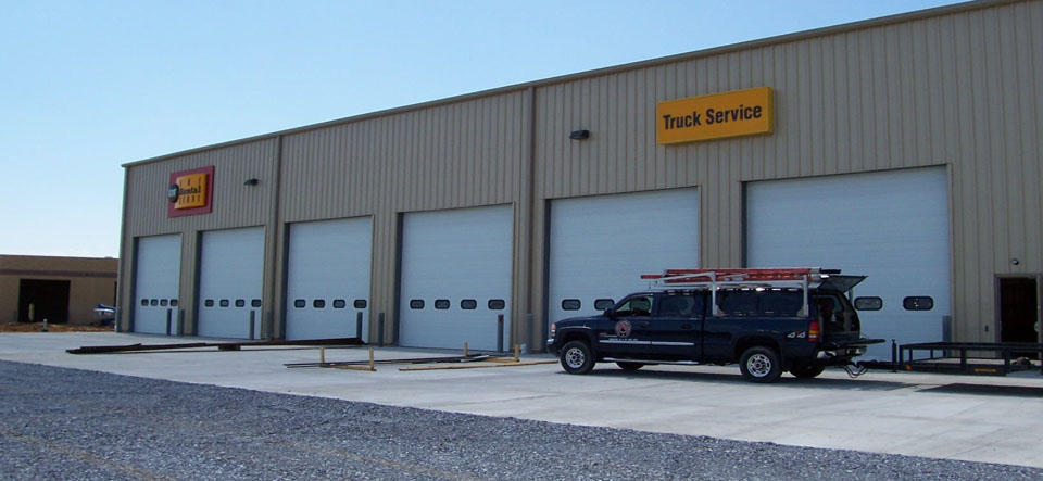 truck and equipment dealership with six garage doors
