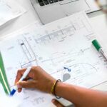 woman marking up technical drawings