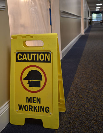 men working sign