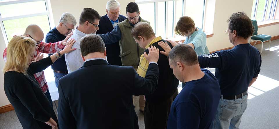 group of adults praying