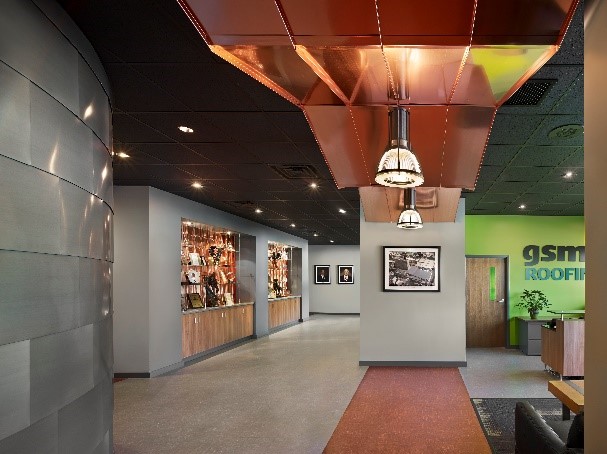 business lobby with brass ceiling and gray walls