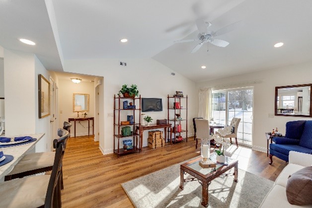 living room with white walls and natural lifht and wood floor