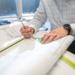 hands drawing on blueprint