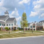 Exterior side view of the Charles Frey Academic Center at Lancaster Bible College, showcasing the modern brick facade and main entrance.