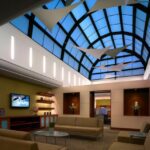 Interior view of Shire Inc.’s renovated conference center featuring open workspaces, booth seating, and natural light in a modern corporate setting.